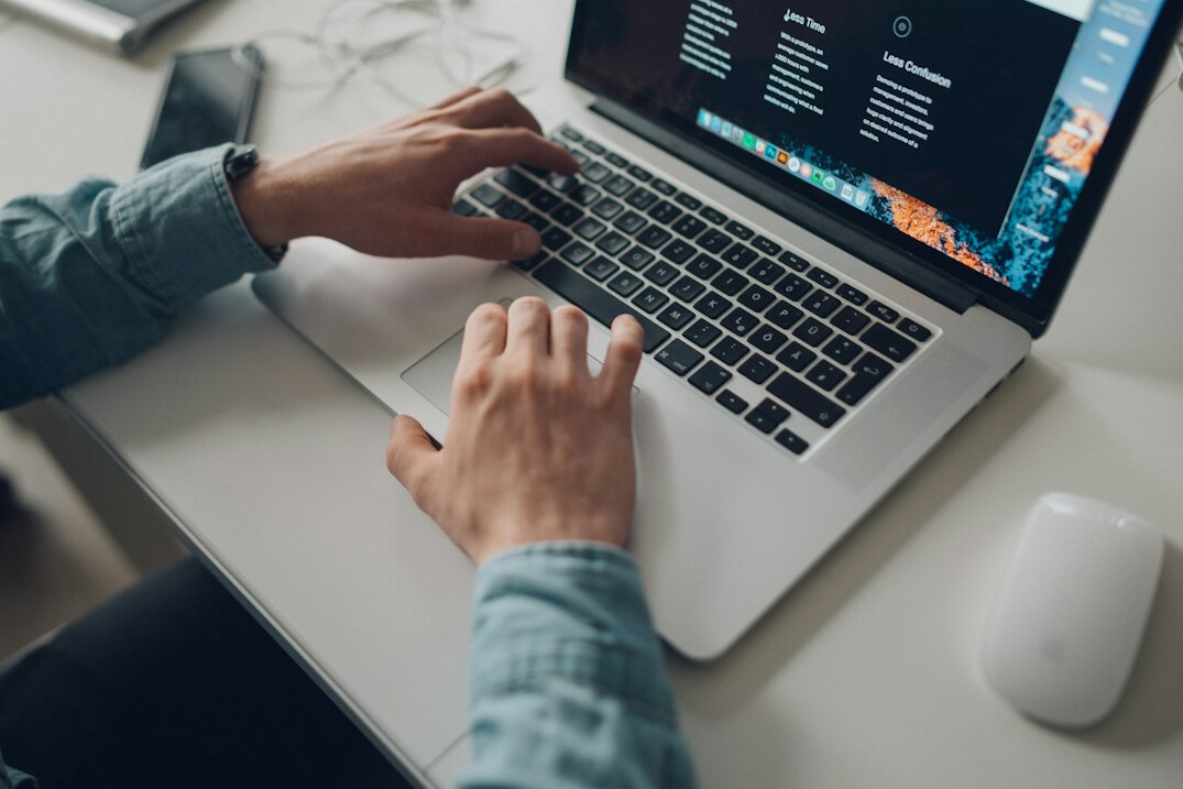 programmer typing on laptop