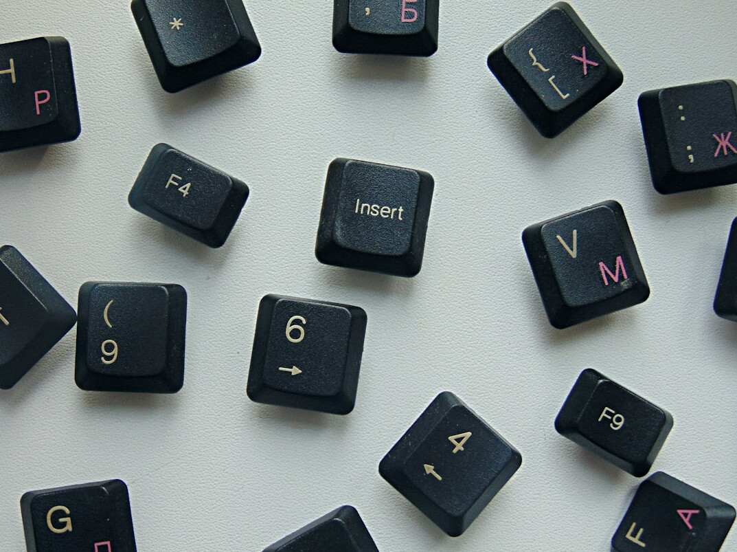 Close-up of hands typing code on a laptop keyboard